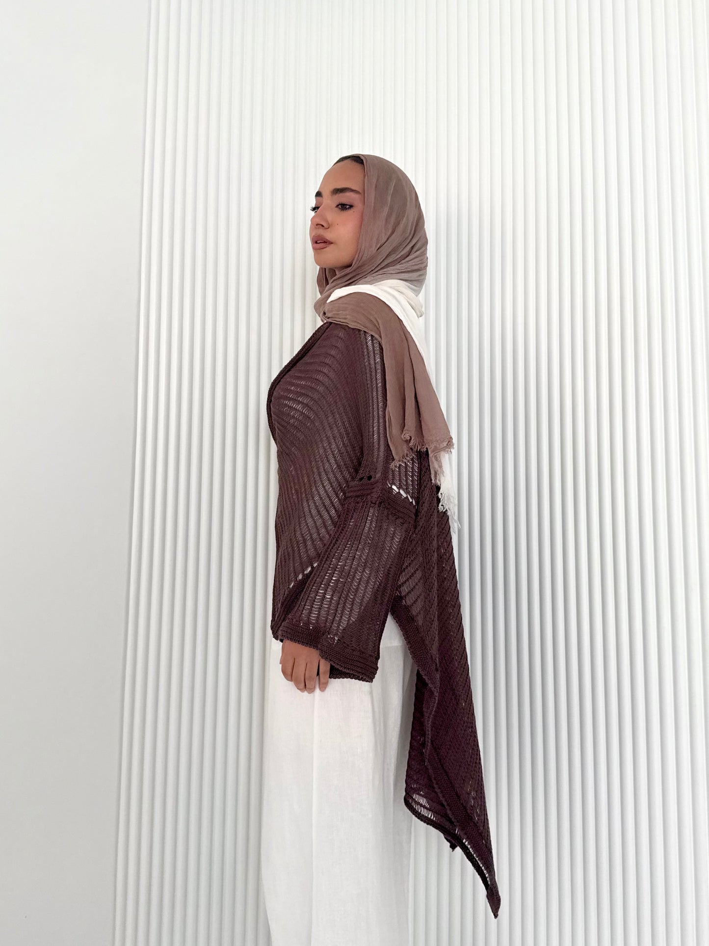Brown convoluted high and low knitted top