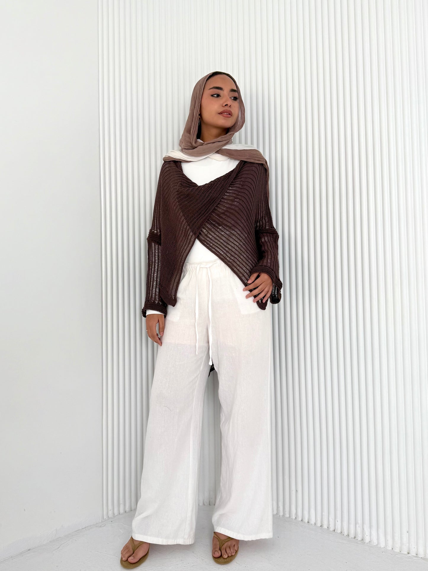 Brown convoluted high and low knitted top