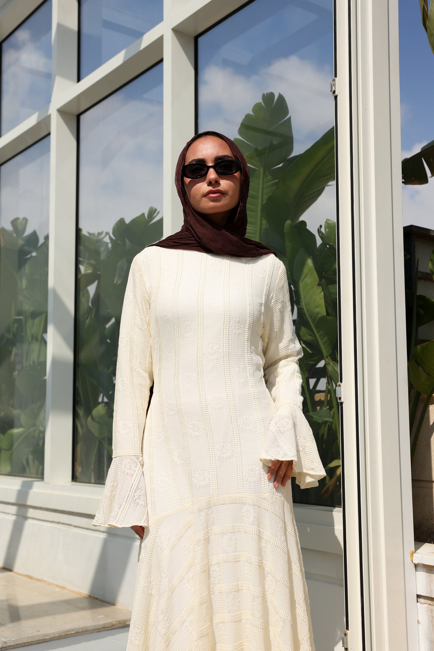 lace dress with a unique design in brown , fully lined." فستان من الدانتيل الفاخرباللون الكريم، يجسد براعة التصميم بتفاصيل فريدة وبطانة كامله ناعمة تمنحكِ رقياً لا يضاهى."