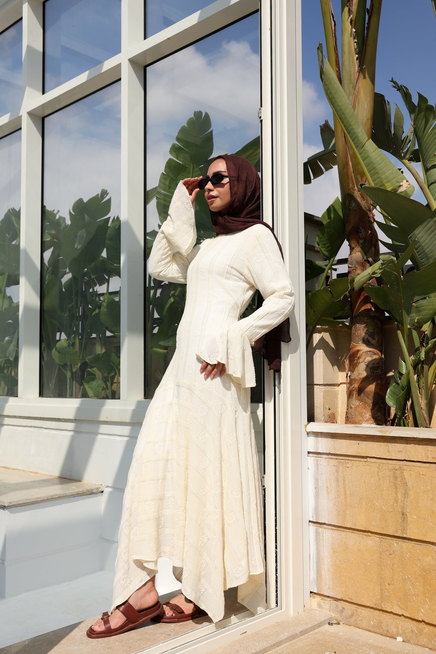 lace dress with a unique design in brown , fully lined." فستان من الدانتيل الفاخرباللون الكريم، يجسد براعة التصميم بتفاصيل فريدة وبطانة كامله ناعمة تمنحكِ رقياً لا يضاهى."