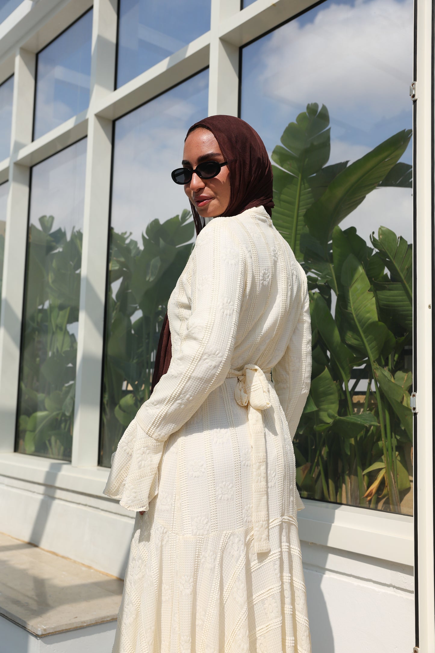 lace dress with a unique design in brown , fully lined." فستان من الدانتيل الفاخرباللون الكريم، يجسد براعة التصميم بتفاصيل فريدة وبطانة كامله ناعمة تمنحكِ رقياً لا يضاهى."