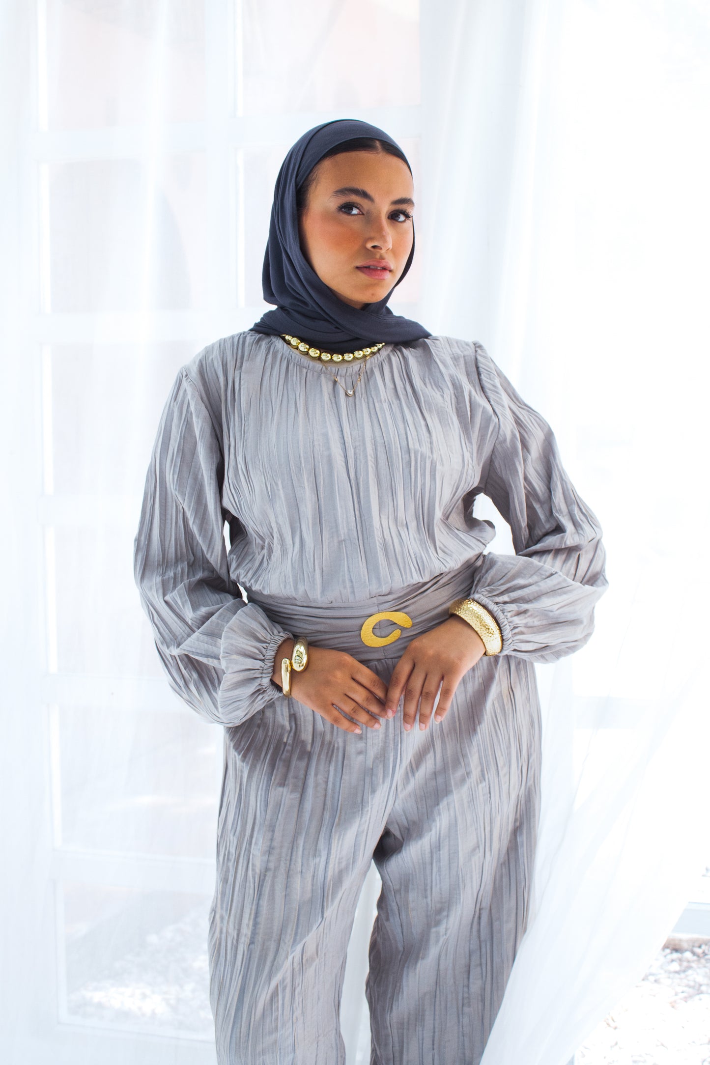 Shimmered crashed cotton jumpsuit in gray with golden brooch
