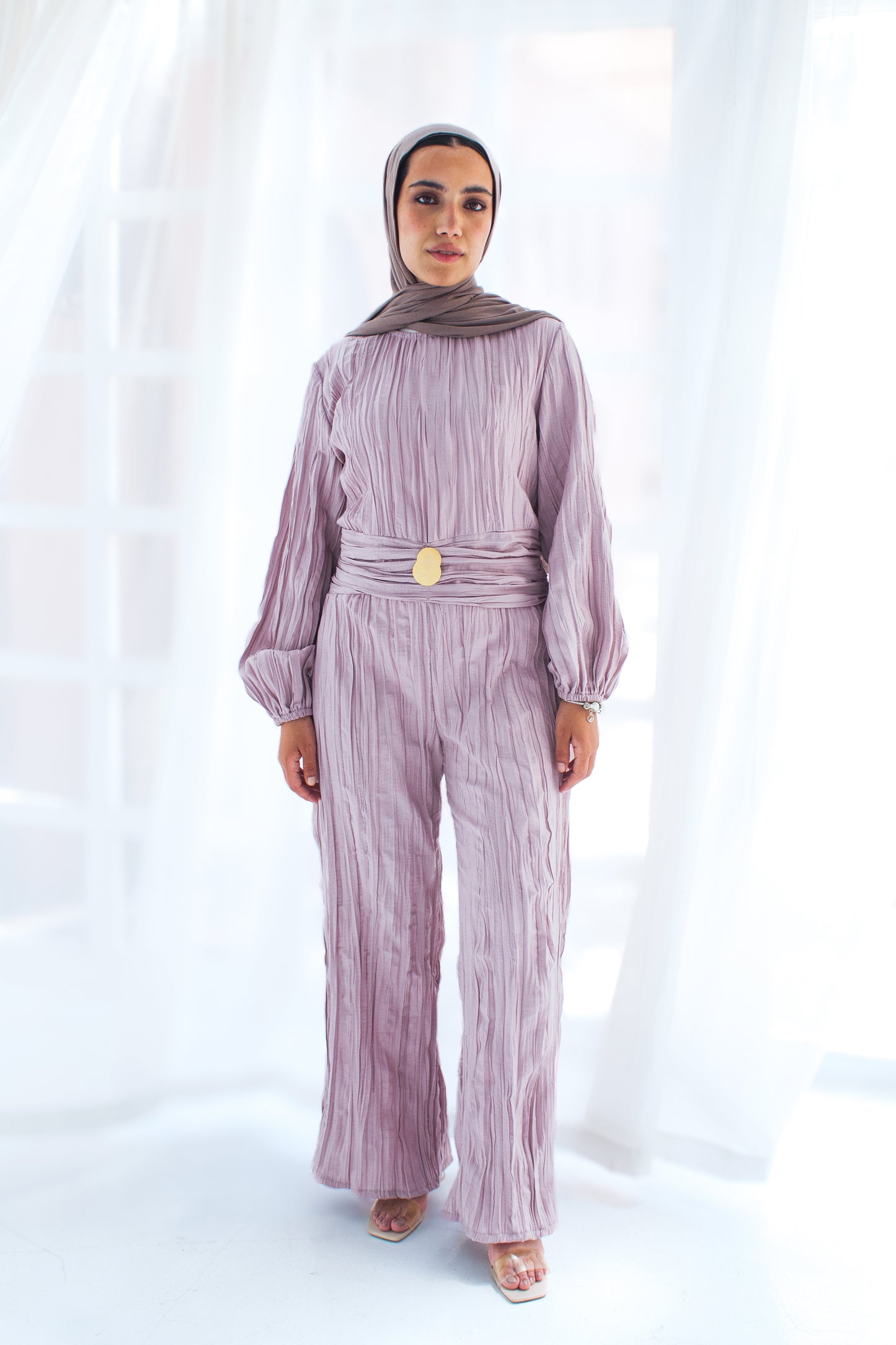 Shimmered crashed cotton jumpsuit in light mauve with golden brooch
