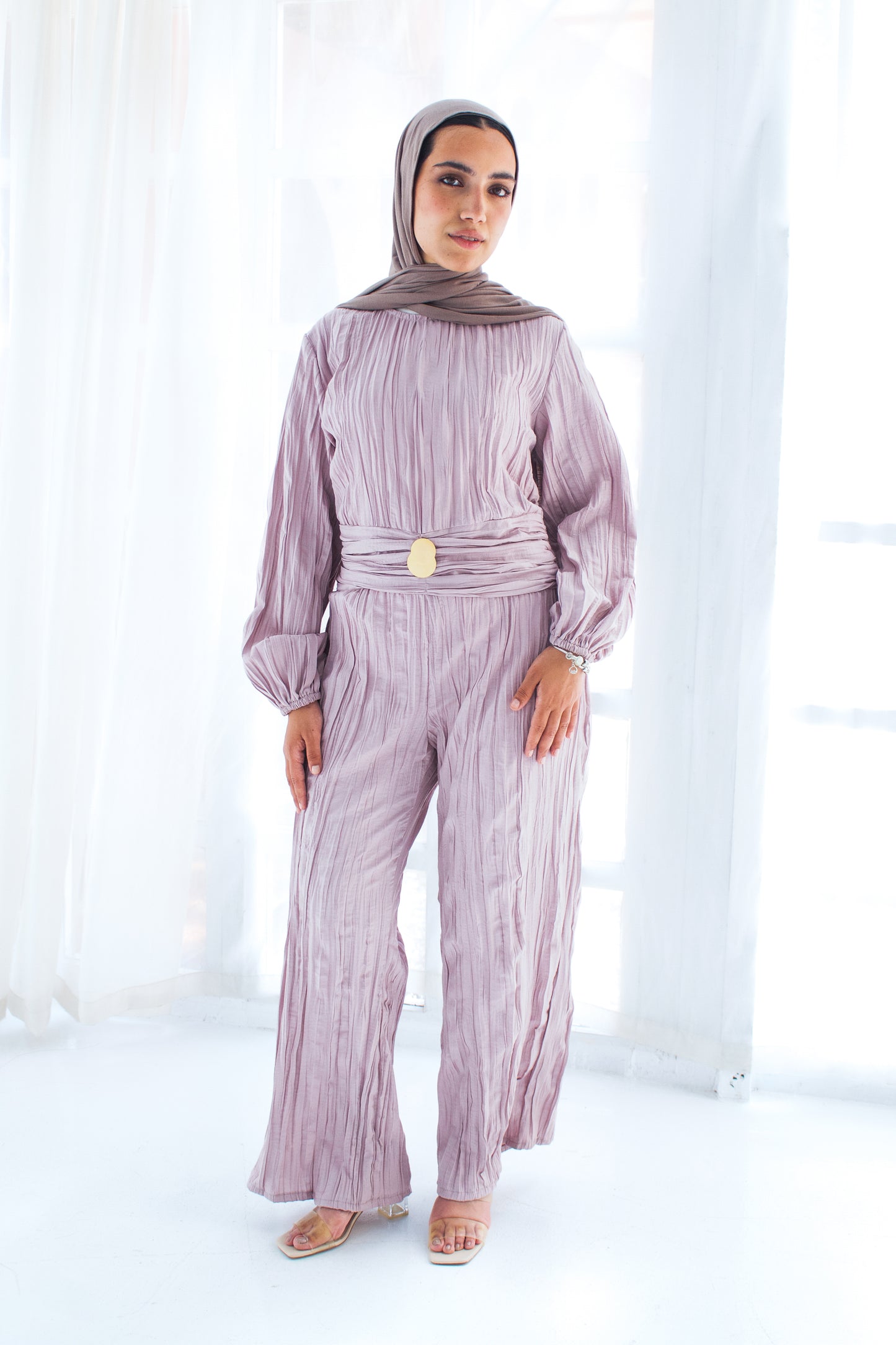 Shimmered crashed cotton jumpsuit in light mauve with golden brooch