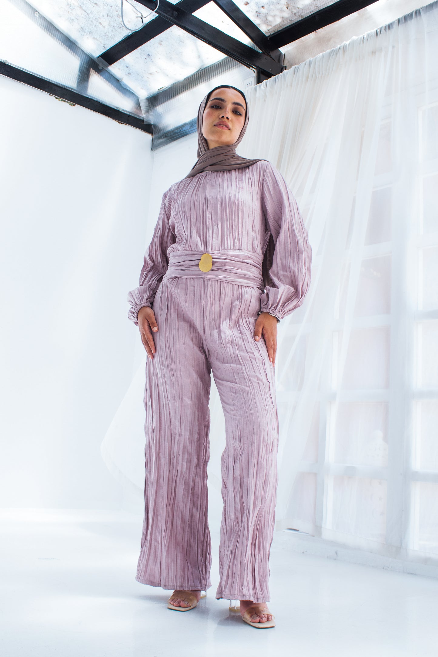 Shimmered crashed cotton jumpsuit in light mauve with golden brooch