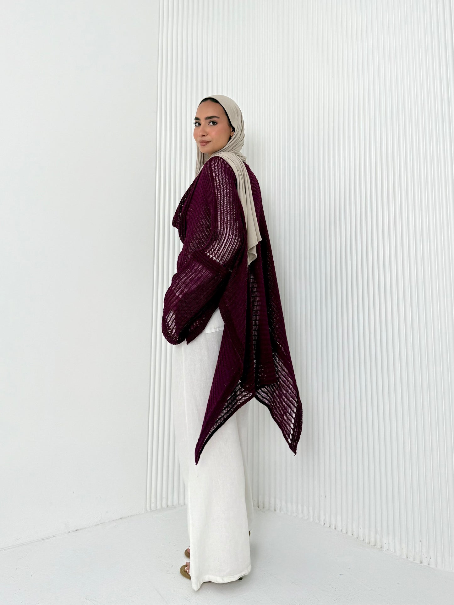Burgundy convoluted high and low knitted top