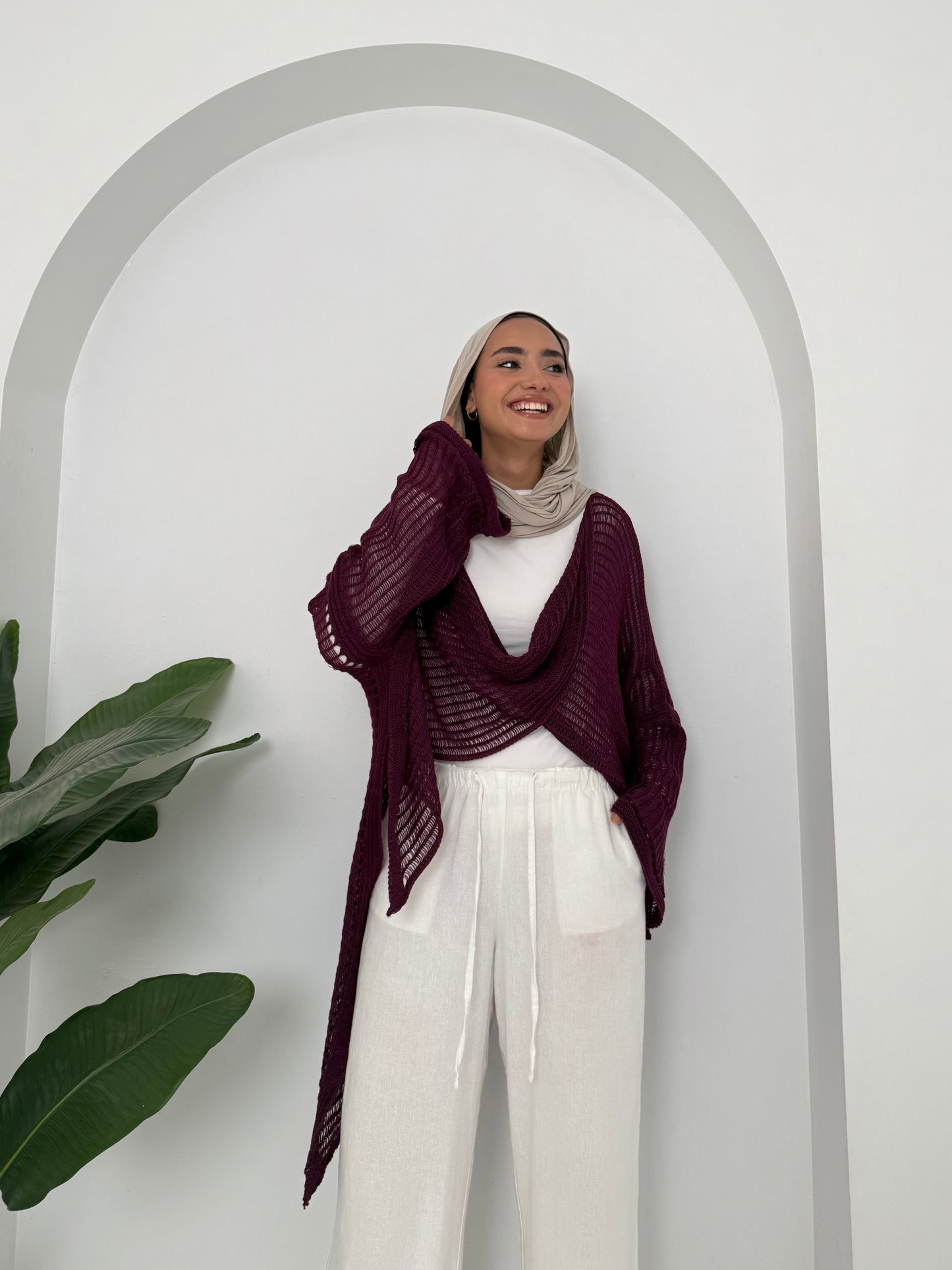 Burgundy convoluted high and low knitted top
