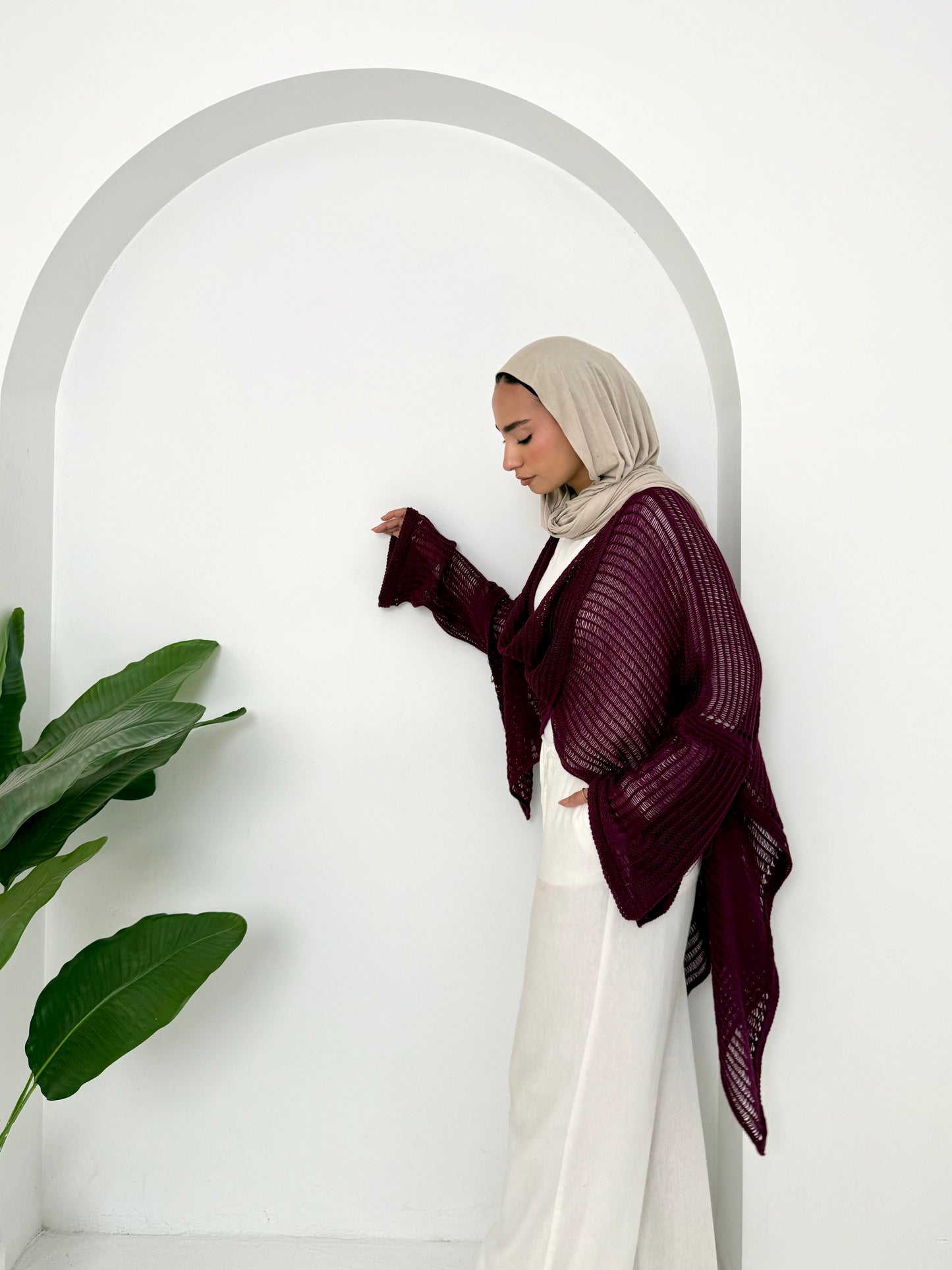 Burgundy convoluted high and low knitted top